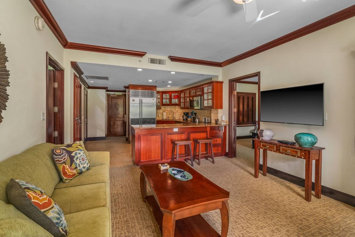 4-820 Kuhio Highway, Unit E103 Kapaa, HI 96746 - Photo 5 of 24 a living room with furniture and a flat screen tv