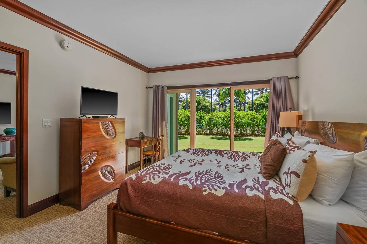 4-820 Kuhio Highway, Unit E103 Kapaa, HI 96746 - Photo 6 of 24 a bed sitting in a bedroom next to a window