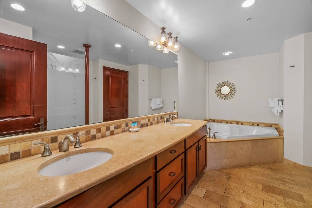 4-820 Kuhio Highway, Unit E103 Kapaa, HI 96746 - Photo 8 of 24 a spacious bathroom with a sink double vanity and a mirror