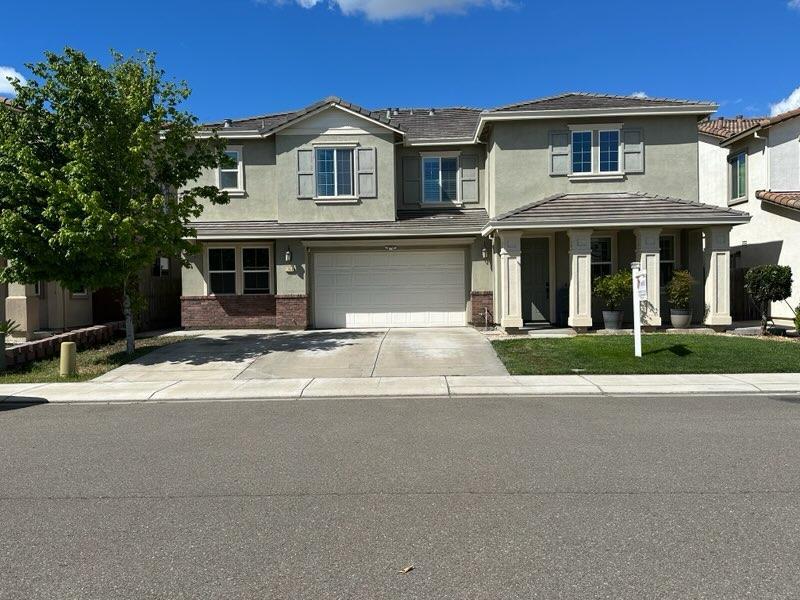 1749 Ettle Street Manteca, CA 95337 - Photo 1 of 12 a front view of a house with a yard
