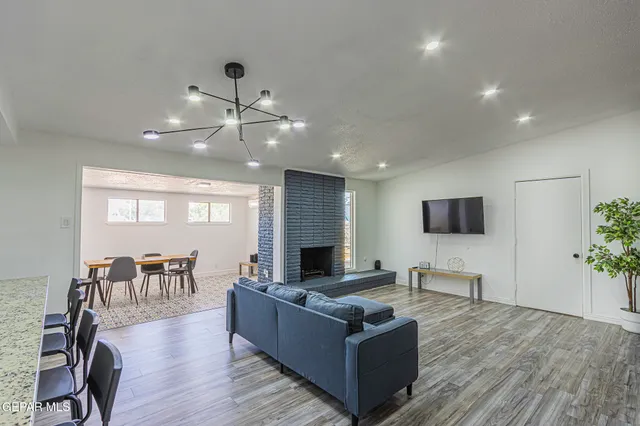 a living room with furniture a fireplace and a flat screen tv