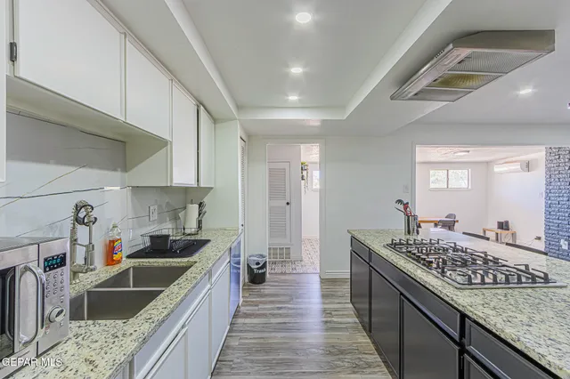 a kitchen with a sink stove and refrigerator