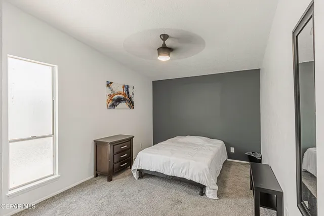 a bedroom with a bed and a window