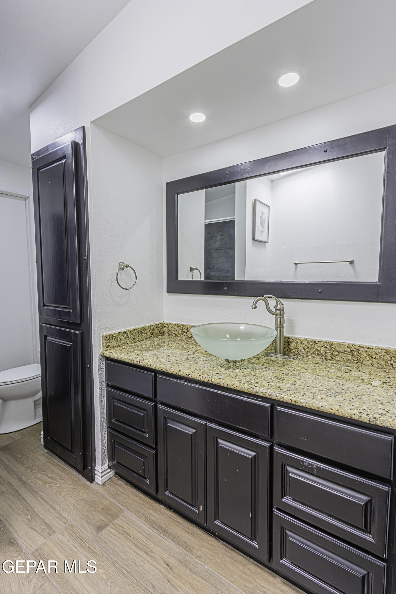 2425 Fir Street El Paso, TX 79925 - Photo 8 of 11 a bathroom with a granite countertop sink and a mirror