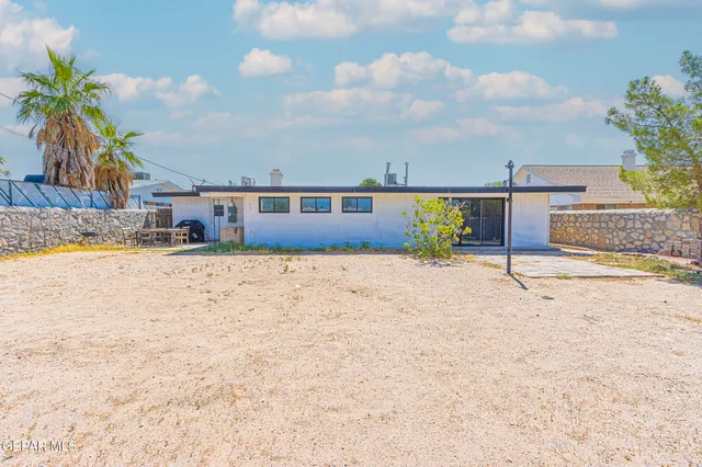 a house view with a sitting space and glass windows