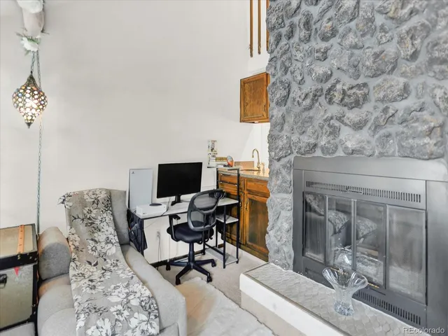 a work room with furniture and a fireplace