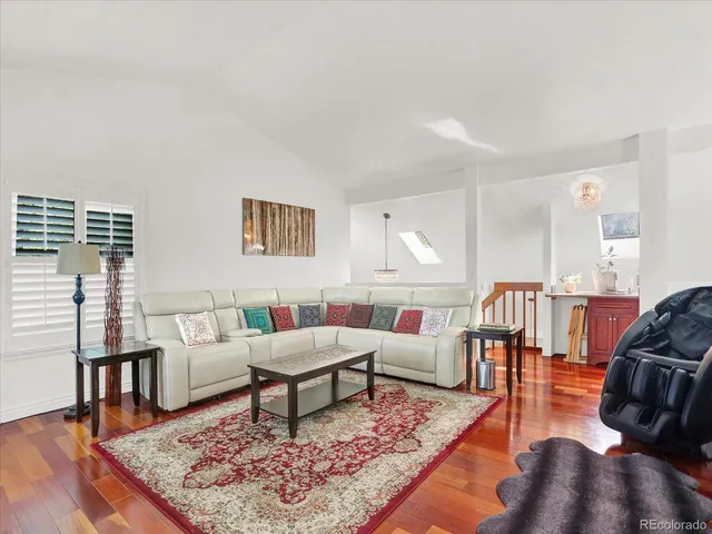a living room with furniture rug and wooden floor