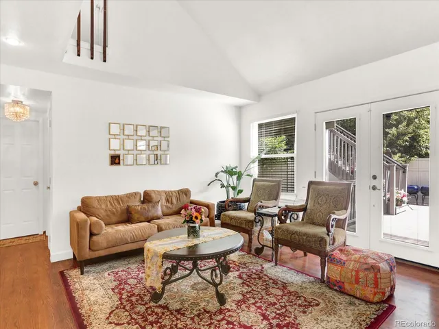 a living room with furniture wooden floor and a table