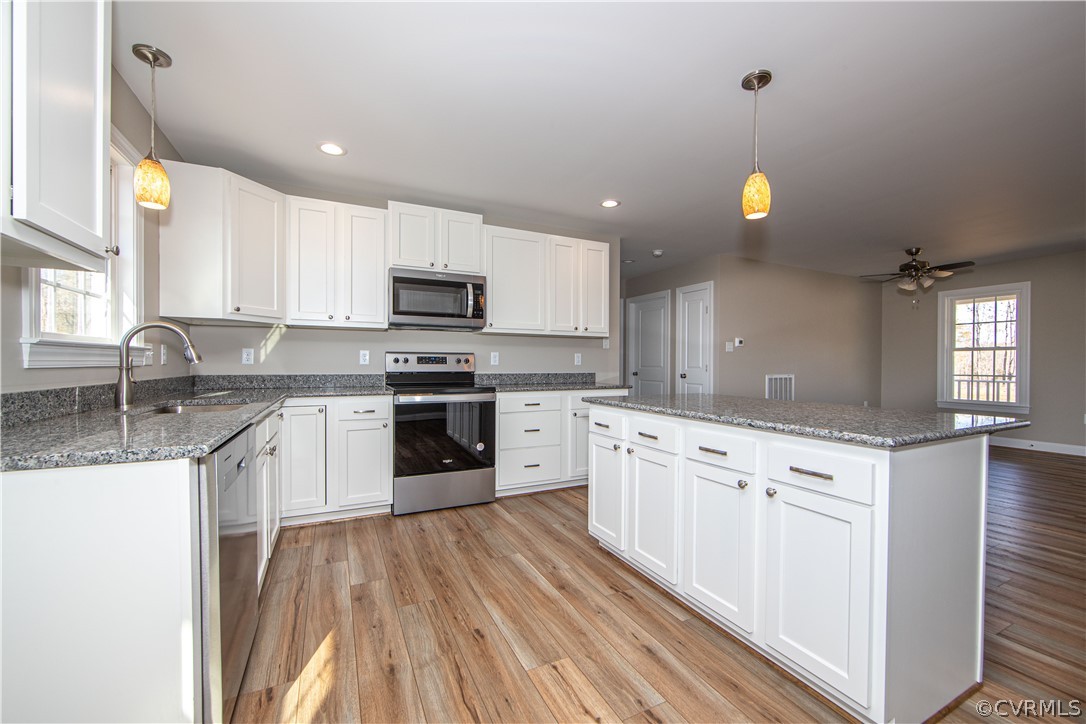 360 Vogel Road Cumberland, VA 23040 - Photo 11 of 25 a kitchen with granite countertop a sink stainless steel appliances and cabinets