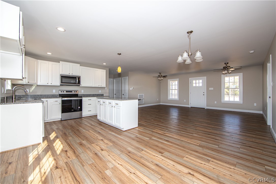 360 Vogel Road Cumberland, VA 23040 - Photo 12 of 25 a view of kitchen and kitchen with sink wooden floor and cabinets