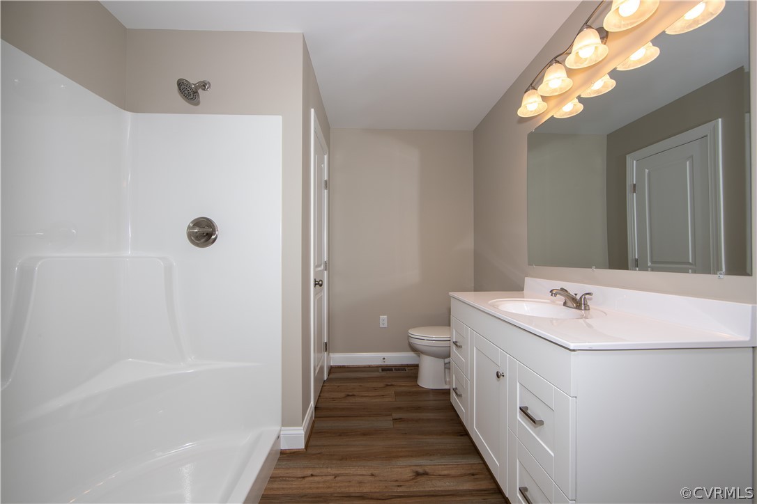 360 Vogel Road Cumberland, VA 23040 - Photo 18 of 25 a bathroom with a sink a toilet a mirror and shower