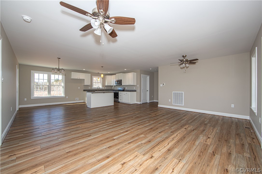 360 Vogel Road Cumberland, VA 23040 - Photo 4 of 25 wooden floor in an empty room with a window