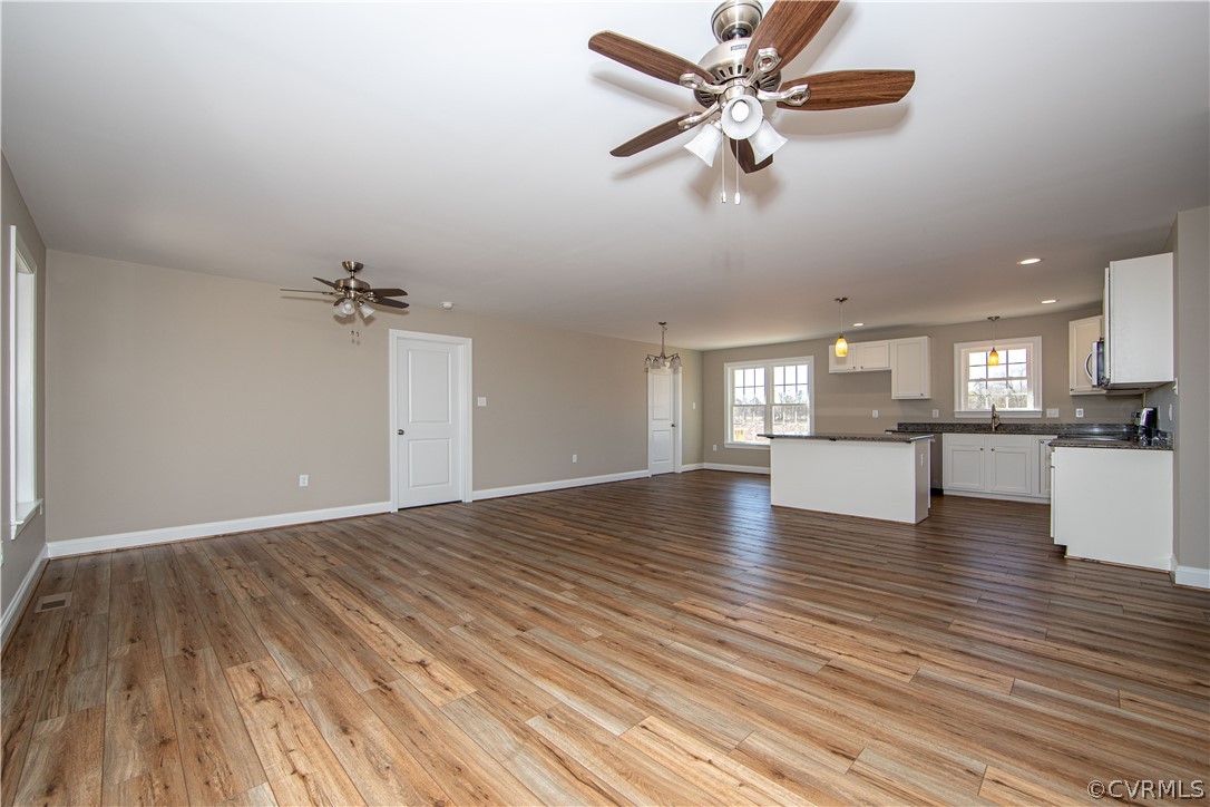 360 Vogel Road Cumberland, VA 23040 - Photo 5 of 25 a view of an empty room with a window and wooden floor