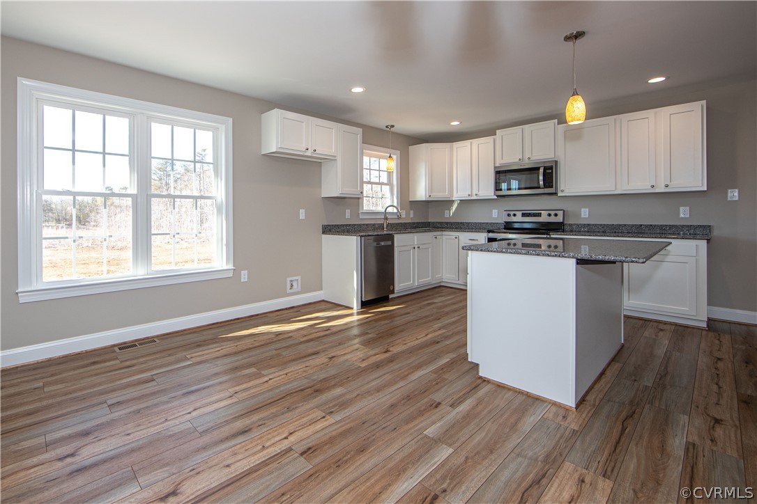 360 Vogel Road Cumberland, VA 23040 - Photo 8 of 25 a kitchen with stainless steel appliances granite countertop a stove top oven a sink dishwasher a refrigerator and white cabinets with wooden floor