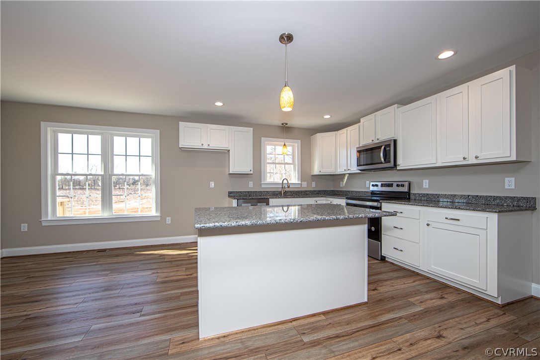 360 Vogel Road Cumberland, VA 23040 - Photo 9 of 25 a kitchen with stainless steel appliances granite countertop a sink a stove and cabinets with wooden floor