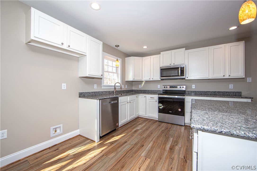 360 Vogel Road Cumberland, VA 23040 - Photo 10 of 25 a kitchen with granite countertop a stove a sink and a microwave