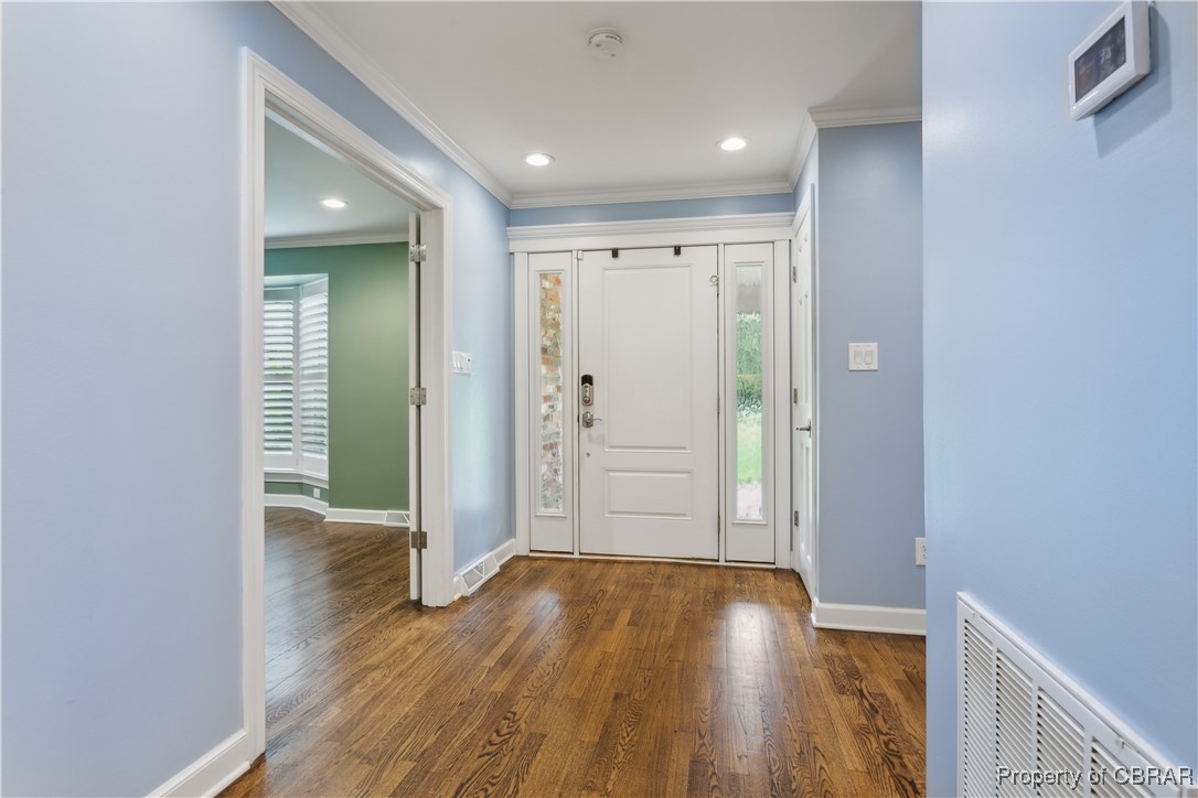 9300 Marlfield Road Gloucester, VA 23061 - Photo 6 of 50 Foyer entrance with crown molding and dark hardwood / wood-style flooring