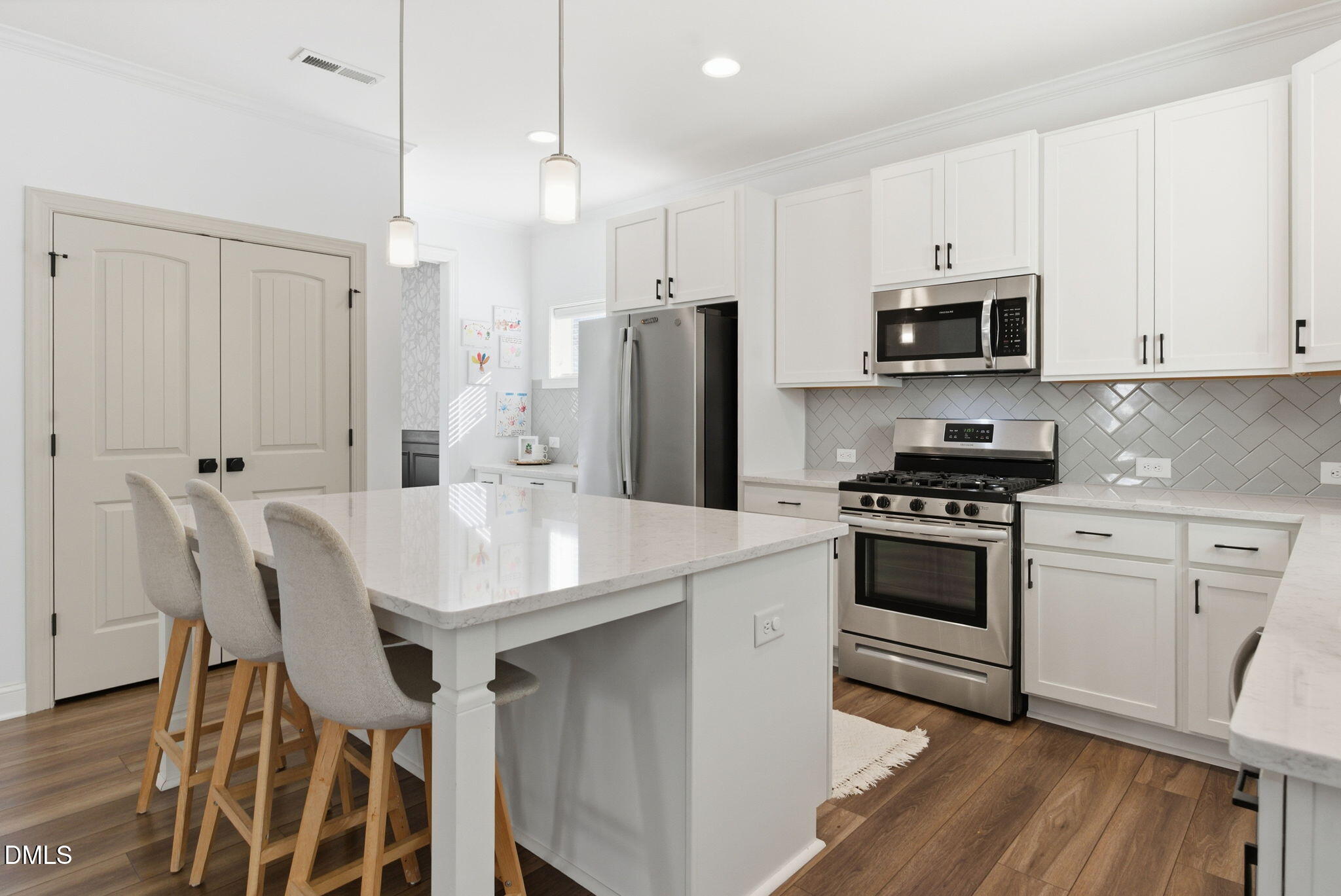 513 Ingram Ridge Court Knightdale, NC 27545 - Photo 19 of 74 a kitchen with stainless steel appliances a stove a sink island and a refrigerator