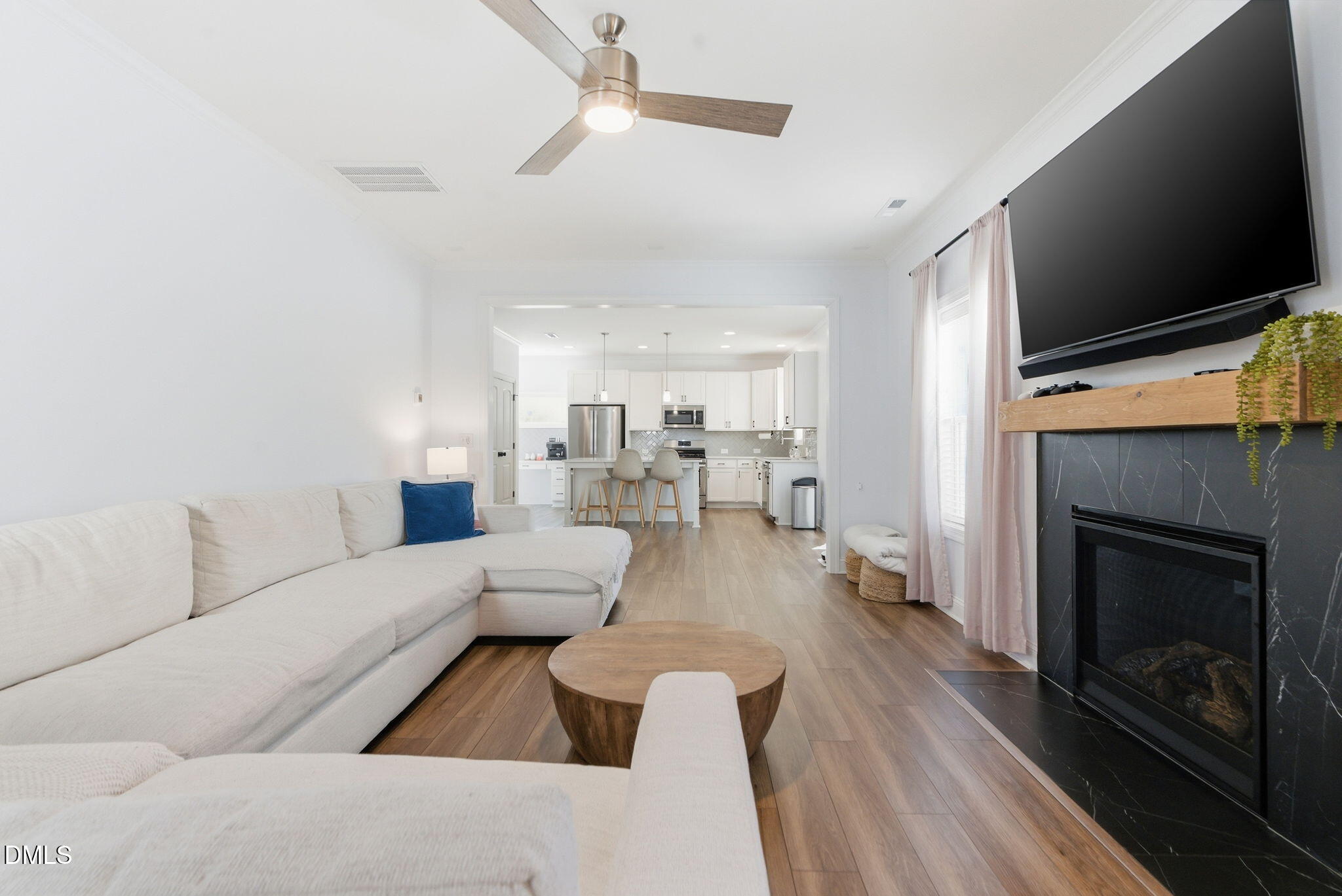 513 Ingram Ridge Court Knightdale, NC 27545 - Photo 30 of 74 a living room with furniture a flat screen tv and a fireplace