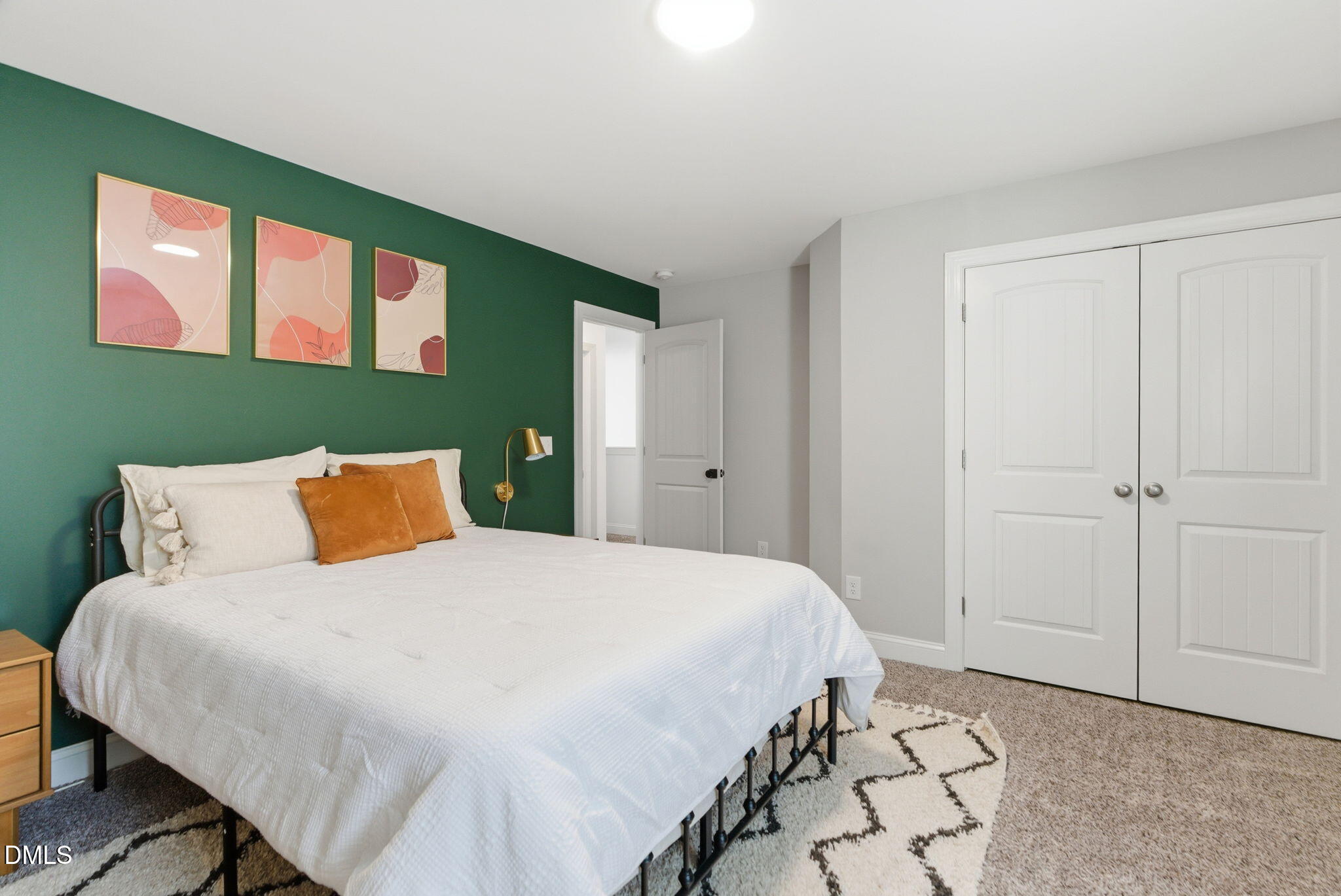 513 Ingram Ridge Court Knightdale, NC 27545 - Photo 60 of 74 a bedroom with a large bed and a potted plant