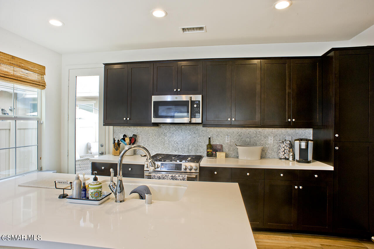 165 Stonegate Road Camarillo, CA 93010 - Photo 11 of 33 a kitchen with a sink and a refrigerator