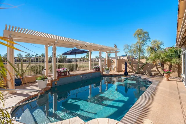 an aerial view of a house with big yard and large trees