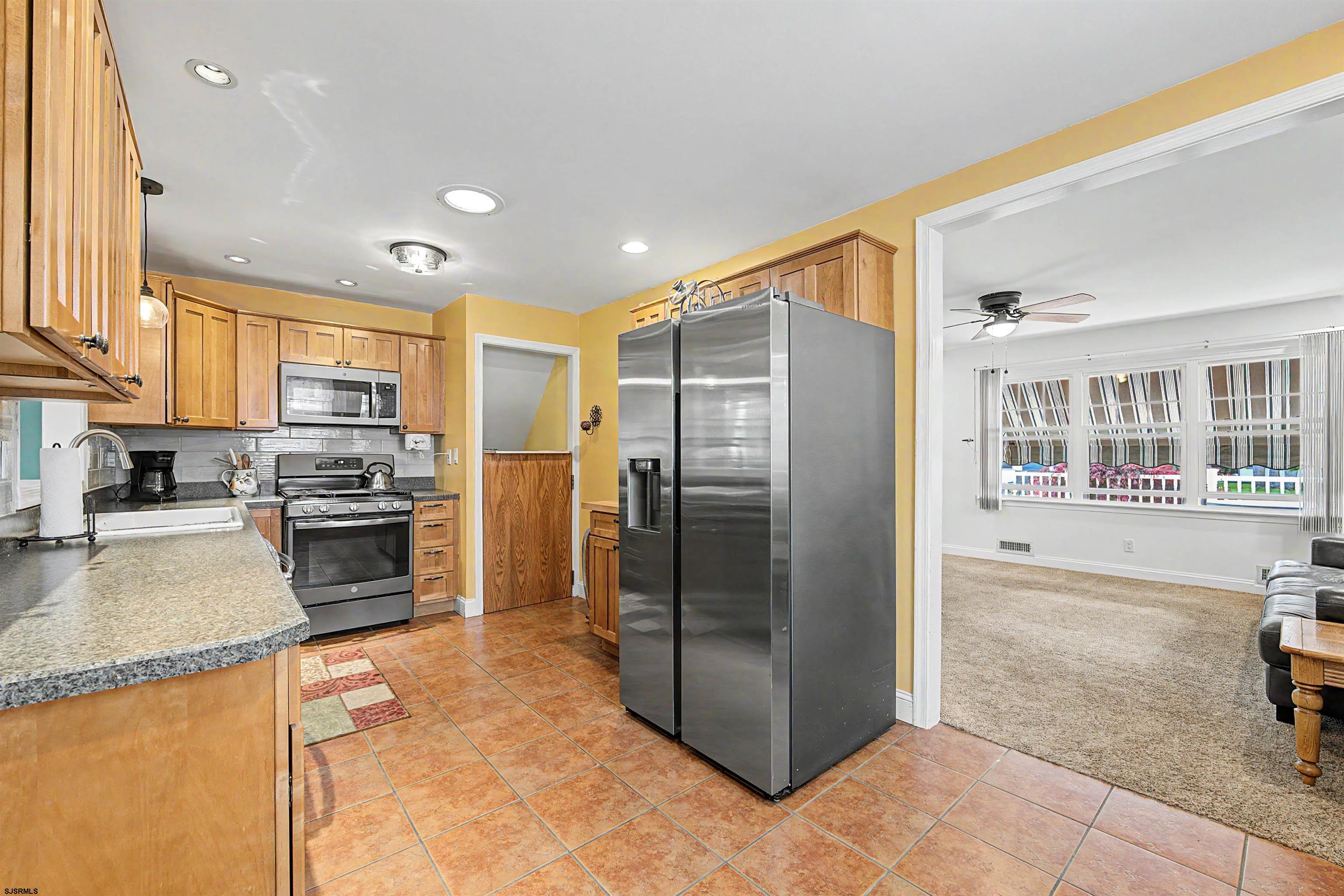 125 Exton Road Somers Point, NJ 08244 - Photo 11 of 35 a kitchen with stainless steel appliances granite countertop a refrigerator a stove and a sink