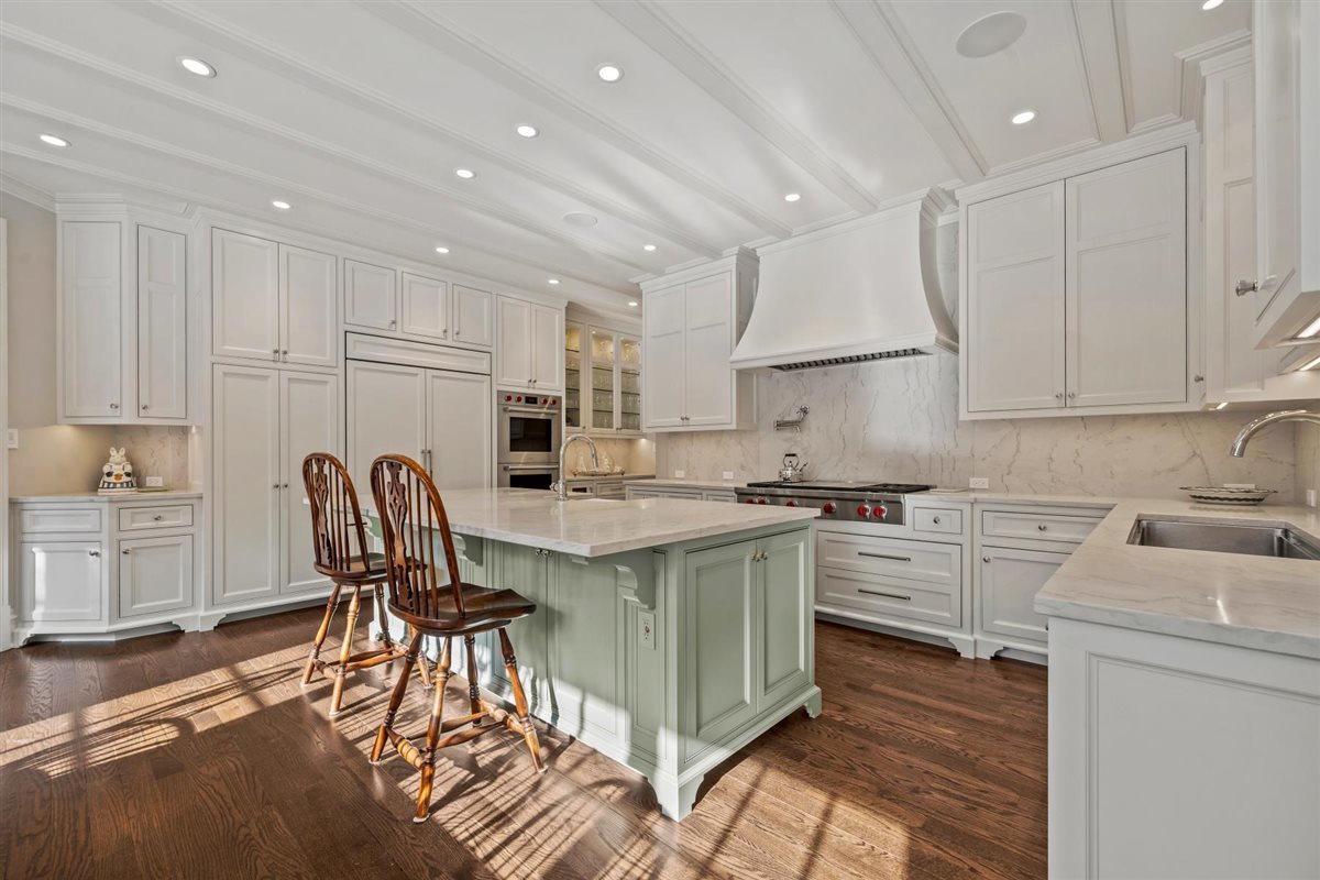 745 East Woodland Road Lake Forest, IL 60045 - Photo 21 of 77 a kitchen with stainless steel appliances granite countertop a stove a sink a refrigerator and white cabinets with wooden floor
