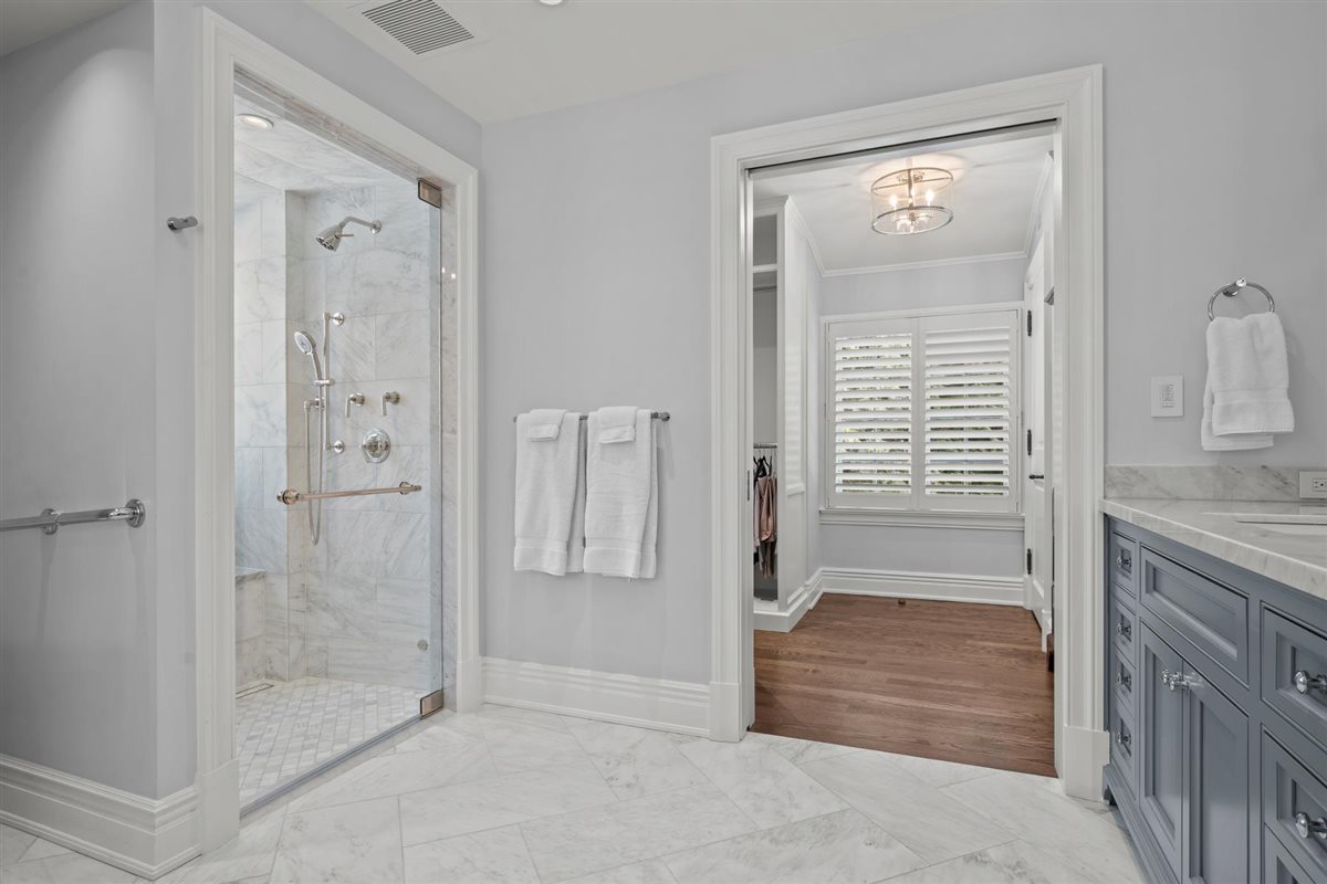 745 East Woodland Road Lake Forest, IL 60045 - Photo 46 of 77 a bathroom with a granite countertop sink a mirror and a shower