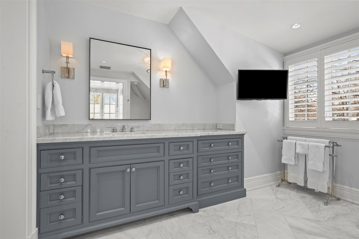 745 East Woodland Road Lake Forest, IL 60045 - Photo 47 of 77 a spacious bathroom with a granite countertop sink and a mirror