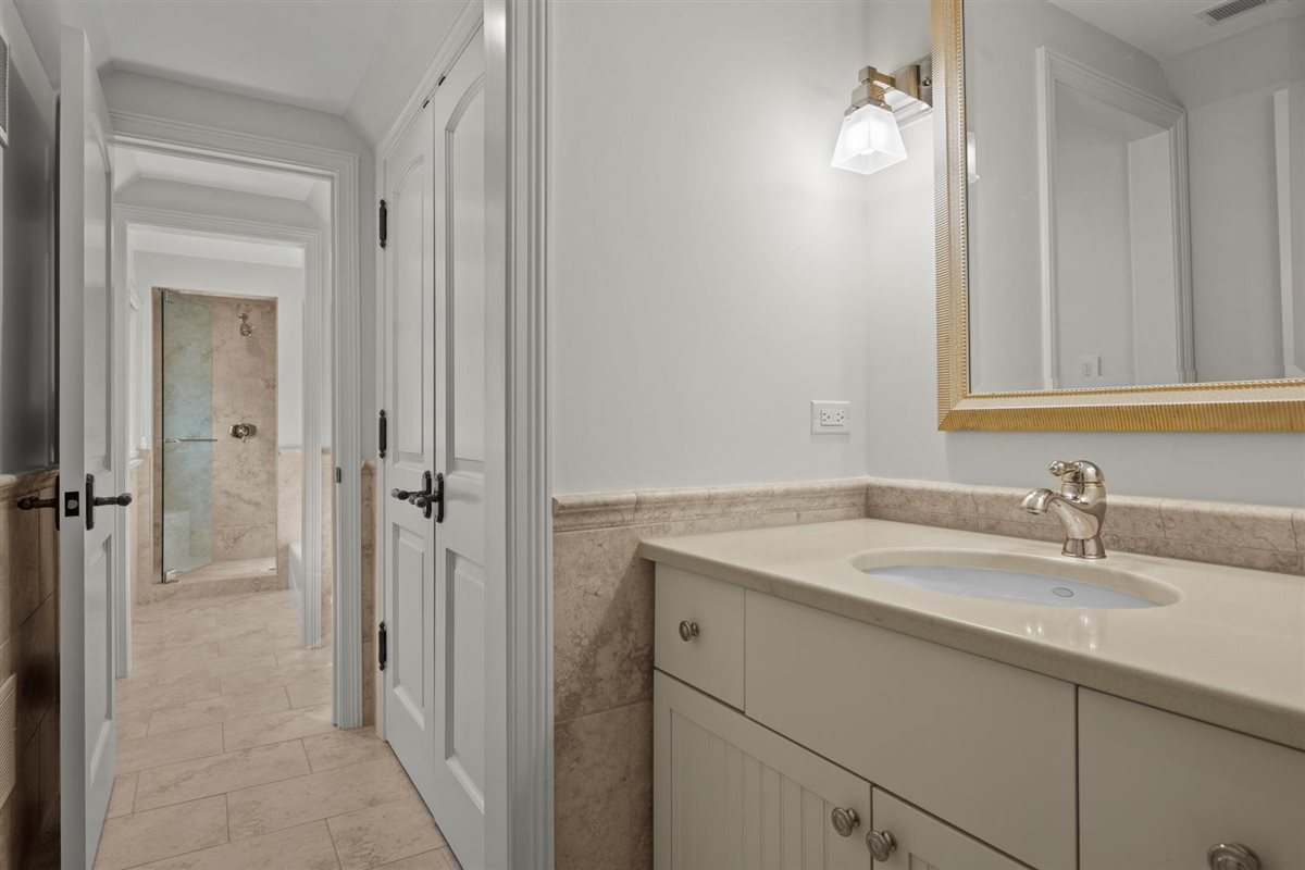 745 East Woodland Road Lake Forest, IL 60045 - Photo 56 of 77 a bathroom with a sink and a mirror