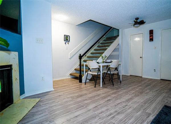 a view of dining room with wooden floor and furniture