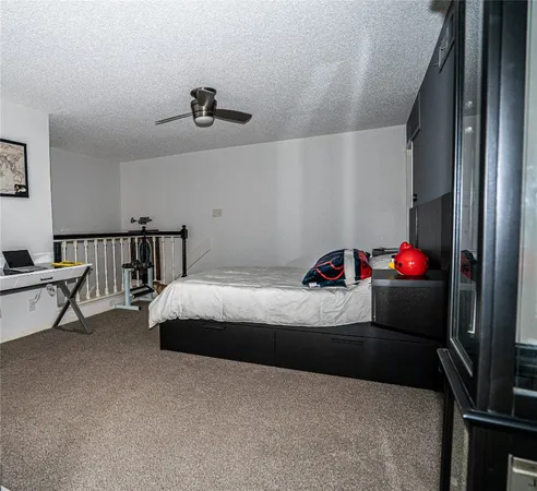 a bedroom with bed and a chandelier