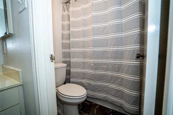 a bathroom with a toilet and a shower