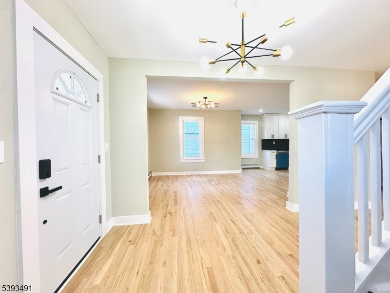 1222 West 3rd Street Plainfield, NJ 07063 - Photo 11 of 50 a view of empty room with wooden floor and fan