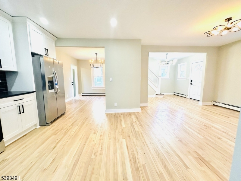 1222 West 3rd Street Plainfield, NJ 07063 - Photo 21 of 50 a view of a kitchen with wooden floor and a sink