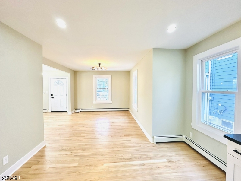1222 West 3rd Street Plainfield, NJ 07063 - Photo 22 of 50 a view of an empty room with window and wooden floor