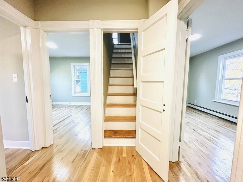 1222 West 3rd Street Plainfield, NJ 07063 - Photo 28 of 50 a view of a hallway with wooden floor and closet