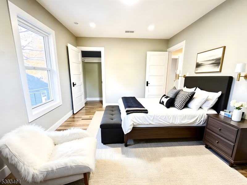 1222 West 3rd Street Plainfield, NJ 07063 - Photo 29 of 50 a bedroom with a bed and wooden floor