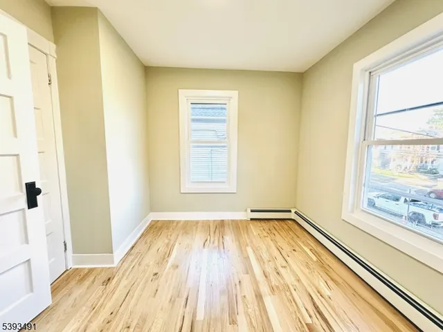 a view of a room with wooden floor and a window