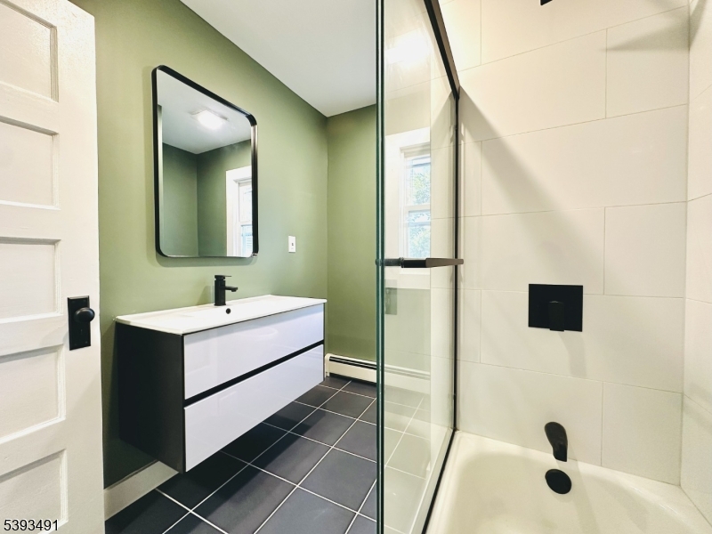 1222 West 3rd Street Plainfield, NJ 07063 - Photo 33 of 50 a bathroom with a tub sink and mirror