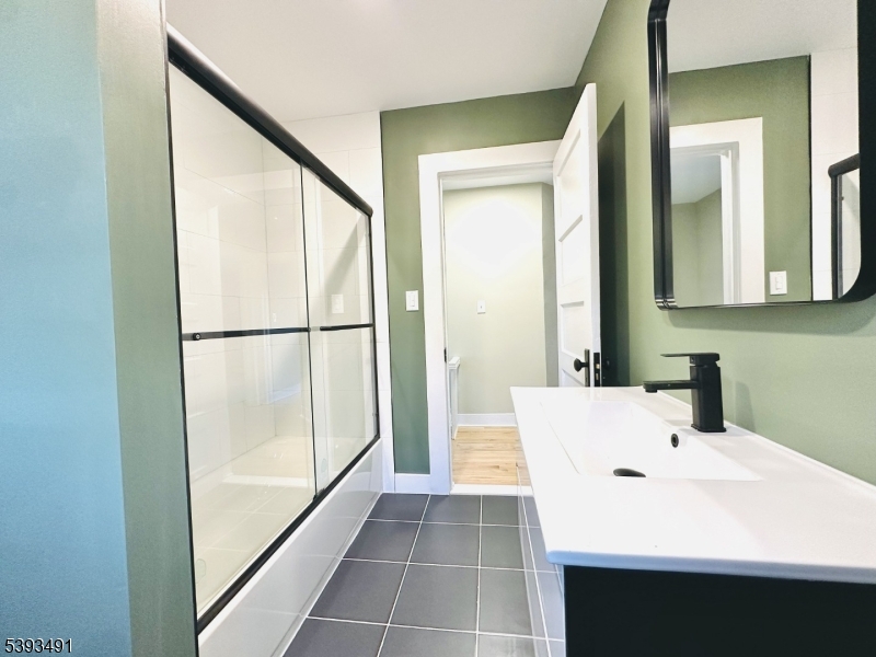 1222 West 3rd Street Plainfield, NJ 07063 - Photo 34 of 50 a bathroom with a sink and a mirror