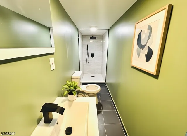 a bathroom with a sink and mirror with bathtub