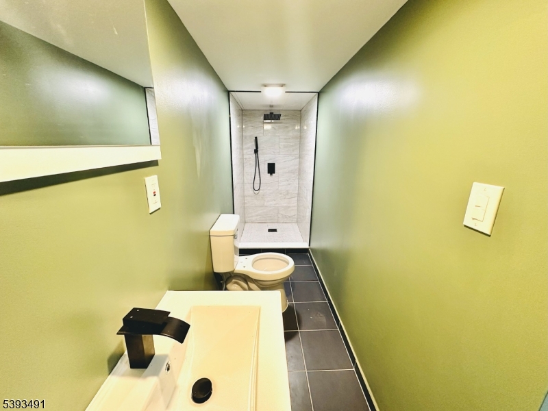 1222 West 3rd Street Plainfield, NJ 07063 - Photo 42 of 50 a bathroom with a granite countertop sink and a mirror