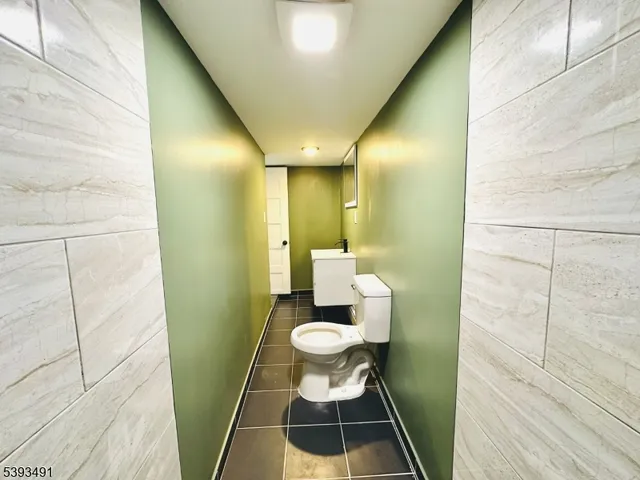 a bathroom with a toilet and a mirror