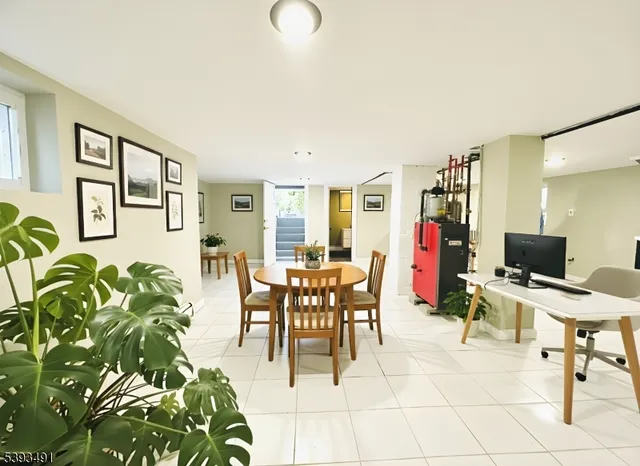 a dining room with furniture a rug and a window