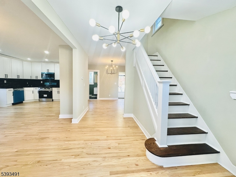 1222 West 3rd Street Plainfield, NJ 07063 - Photo 7 of 50 a view of a kitchen with wooden floor and staircase