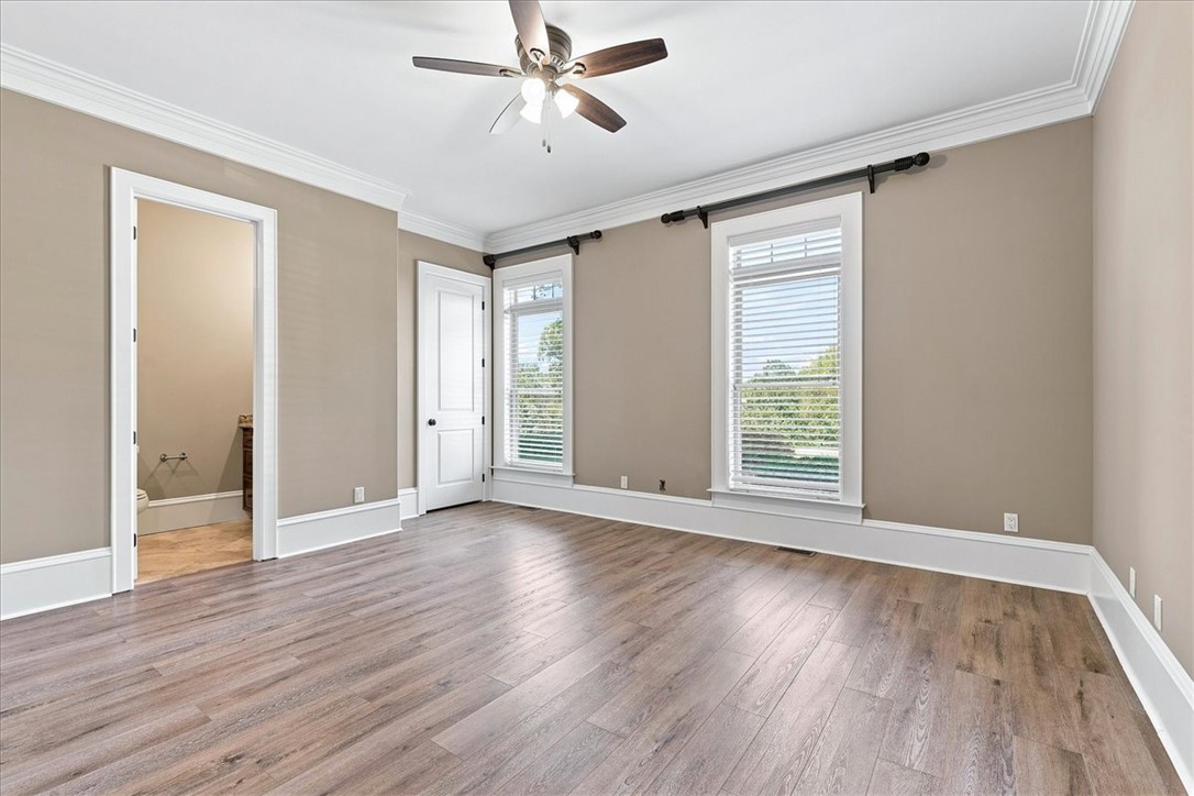 181 Sentell Road Williamston, SC 29697 - Photo 22 of 47 Main floor guest bedroom (2 of 6). Full bath and gleaming floors and classic crown molding frame a sunlit bedroom.