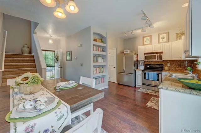 a living room with fireplace furniture and a wooden floor