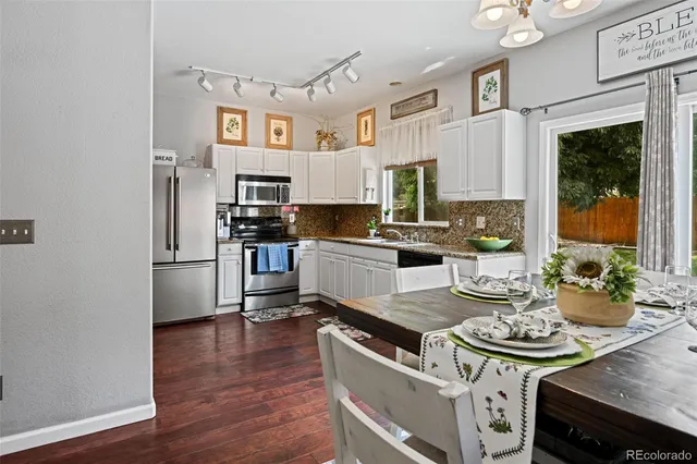 a kitchen with stainless steel appliances a stove a sink and a refrigerator
